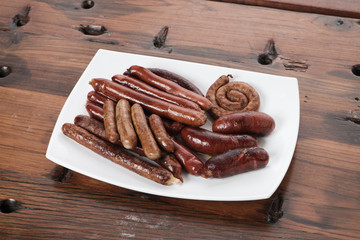 Grilled sausages on wooden board