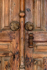 Old wooden door with iron handles. Holy Cross Monastery In Omodos village. Cyprus