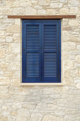 Fototapeta na wymiar Vintage window with wooden shutters in the village of Omodos. Cyprus