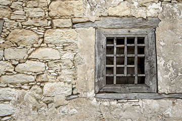 Broken wooden lattice in a window frame in the village of Omodos. Cyprus