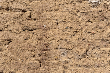 Background of brick wall covered with clay