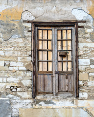 Old wooden door in a brick wall of an old house. Limassol. Cyprus