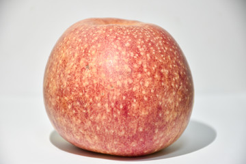 red apple on a white plate