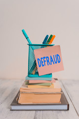 Handwriting text Defraud. Conceptual photo to trick or cheat someone or something in order to get...