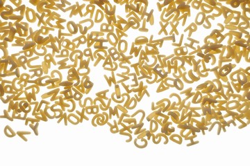 Pasta letters Isolated on a white background.Dry uncooked pasta.Macaroni for kids food.Pasta tiny english letters background.letters pattern