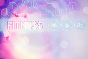 Conceptual hand writing showing Fitness. Concept meaning the state of health and wellbeing and the...
