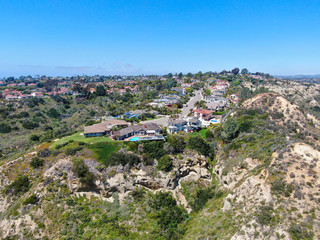 Fototapeta na wymiar Aerial view of upper middle class neighborhood with residential house and swimming pool in a valley in San Diego, California, USA.
