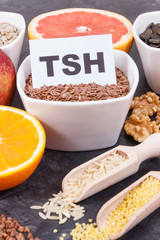 Inscription TSH with nutritious products and ingredients containing vitamins for healthy thyroid