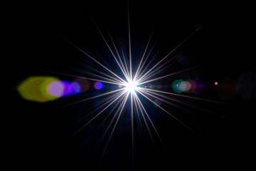 Flare background. Sunlight ray flash effect on black. Star spot or sun shine glow light on lens. Gleams rounded and hexagonal shapes, rainbow halo