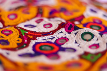 Fototapeta na wymiar multicolour ethnic embroidery,Gujarat india embroidery craft close up view, traditional Indian embroidery,traditional and fashionable handicrafts close up