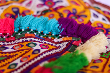 Fototapeta na wymiar multicolour ethnic embroidery,Gujarat india embroidery craft close up view, traditional Indian embroidery,traditional and fashionable handicrafts close up