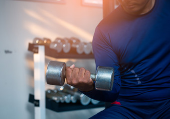 Man exercise working out with dumbbell weights at the gym, Fitness muscular body.