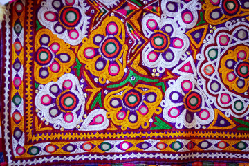 Colorful ethnic belts with mirrors and shells at market in Rajasthan, India, handmade or handicrafts embroidery beautiful view, mirror and bead work Jammu and Kashmir, India. selective focus