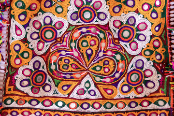 indian Embroidery handmade style background ,Ahir Embroidery vintage style ,Indian patchwork carpet in india,craftsman embroidering cloth in traditional Indian,selective focus