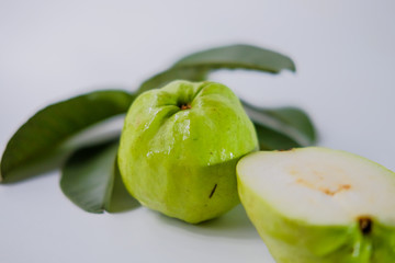 Fresh guava fruit with leaves isolated on a white background