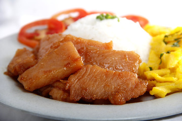 Filipino food called Chicken Tocino or cured chicken meat with rice, tomato scrambled egg on a plate