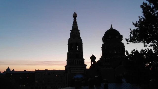 Drone lands down the silhouette of an Orthodox church in Saint Petersburg during sunrise, Russia