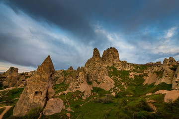 Fototapeta na wymiar Beautiful sandstone rock formations in Cappadocia, Turkey, under stormy, cloudy, sky