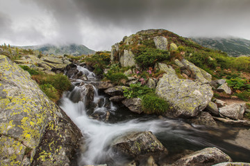 Stormy landscape with granite rocks and glacier lakes in the Transylvanian Alps