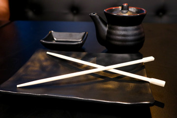 empty black clear set for sushi,plate with Japanese chopstick,saucer on the black table