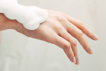 Female hand in soapy foam. Clean hands and personal hygiene