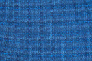 Blue fabric with pronounced texture, weaving threads. Furniture fabric, background.