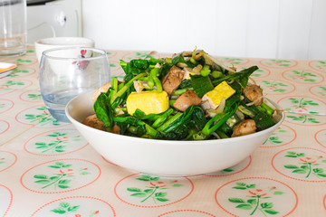 Stir fry vegetables with chicken and tofu.
