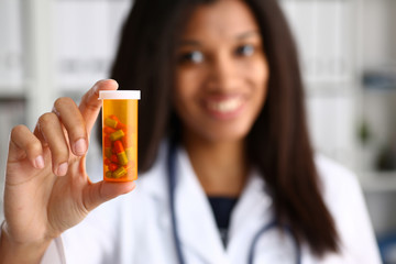 Female black doctor hands hold jar of pills closeup. Panacea life save healthy lifestyle prescribe treatment legal drug store contraception concept