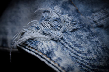 Close-up popular trend ripped jeans or distressed jeans