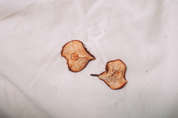 Dry pears on white canvas, yin and yang