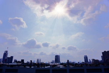The cloudy sky in sunny day above blurred city, blured photo