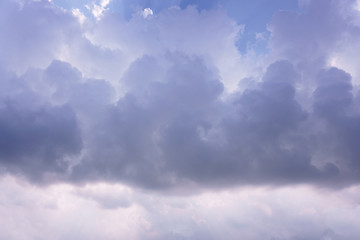 white and gray cloudy sky with bright aura ray of sun beam under deep blue sky , going to be rain