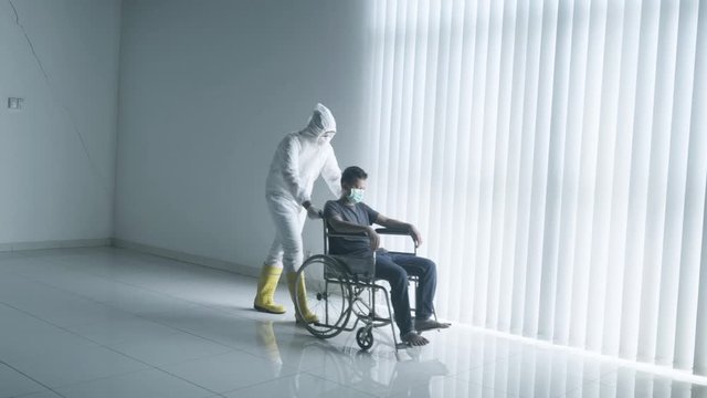Doctor push patient on wheelchair during quarantine