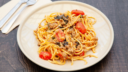 Spaghetti bolognese with tomato, cheese and basil on a plate