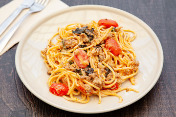 Spaghetti bolognese with tomato, cheese and basil on a plate