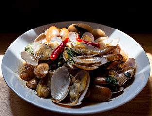Delicious stir fried clams with chili paste on white plate.Thai food.