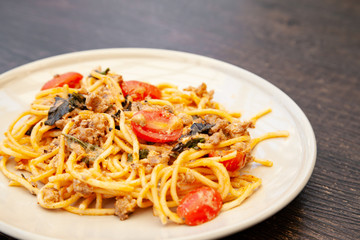 Spaghetti bolognese with tomato, cheese and basil on a plate
