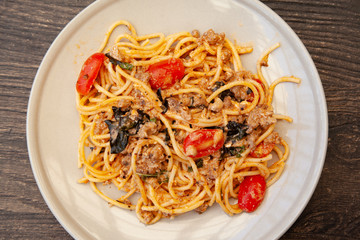 Spaghetti bolognese with tomato, cheese and basil on a plate