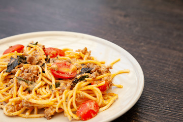 Spaghetti bolognese with tomato, cheese and basil on a plate