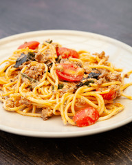Spaghetti bolognese with tomato, cheese and basil on a plate