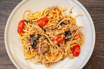 Spaghetti bolognese with tomato, cheese and basil on a plate
