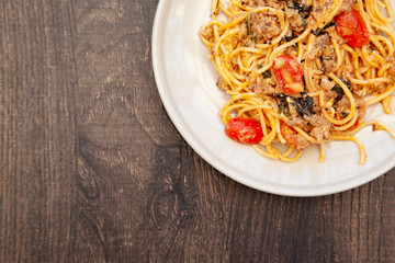 Spaghetti bolognese with tomato, cheese and basil on a plate