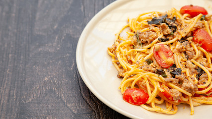 Spaghetti bolognese with tomato, cheese and basil on a plate