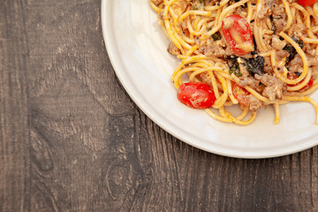 Spaghetti bolognese with tomato, cheese and basil on a plate