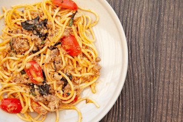 Spaghetti bolognese with tomato, cheese and basil on a plate