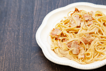 Carbonara pasta, spaghetti with pancetta, egg, hard parmesan cheese and cream sauce. Traditional italian cuisine