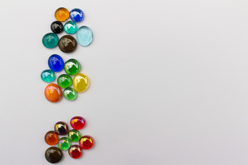 Abstract art design background of colorful glass drop dragon tears on a light neutral background with copy space