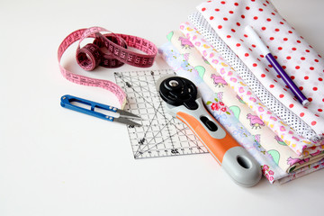 Cotton fabric and sewing supplies on a white background.