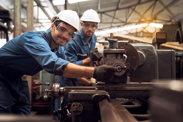 Professional technicians and engineers are working in industrial plants that work on steel.