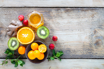 Healthy products for Immunity boosting on wooden background with copy space top view. Lemon, nuts, ginger to immune system.